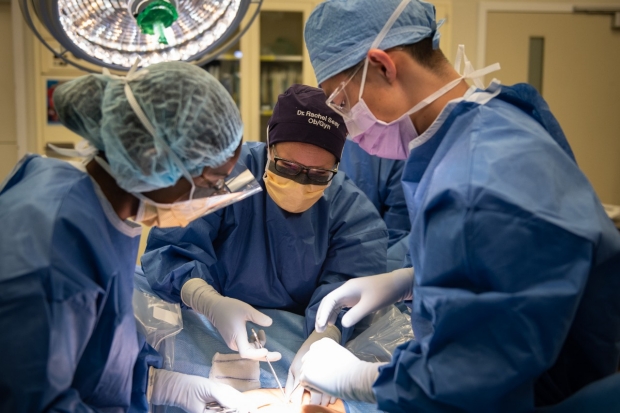 Dr. Seay works with Dr. Liu on a case in the OR.